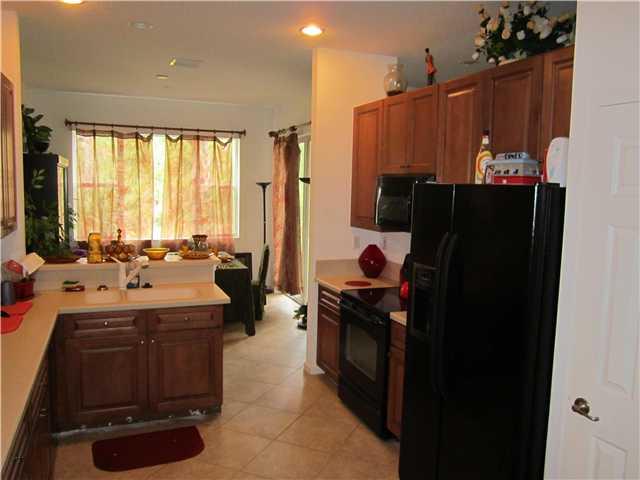 255 Southwest Walking Path Stuart, FL 34997 - Photo 5 of 16 a kitchen with a sink and refrigerator