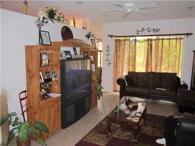 255 Southwest Walking Path Stuart, FL 34997 - Photo 7 of 16 a living room with furniture a window and a chandelier