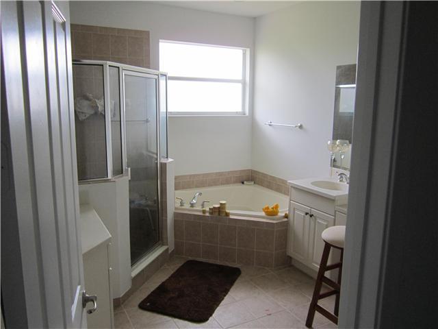 255 Southwest Walking Path Stuart, FL 34997 - Photo 10 of 16 a bathroom with a tub and a shower