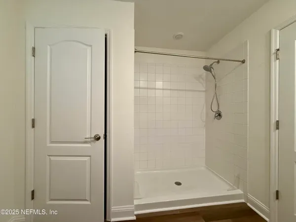 a bathroom with a glass shower door