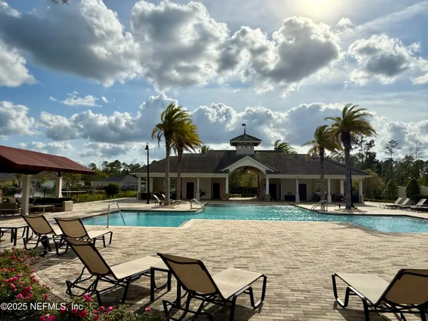 a view of a house with swimming pool and porch