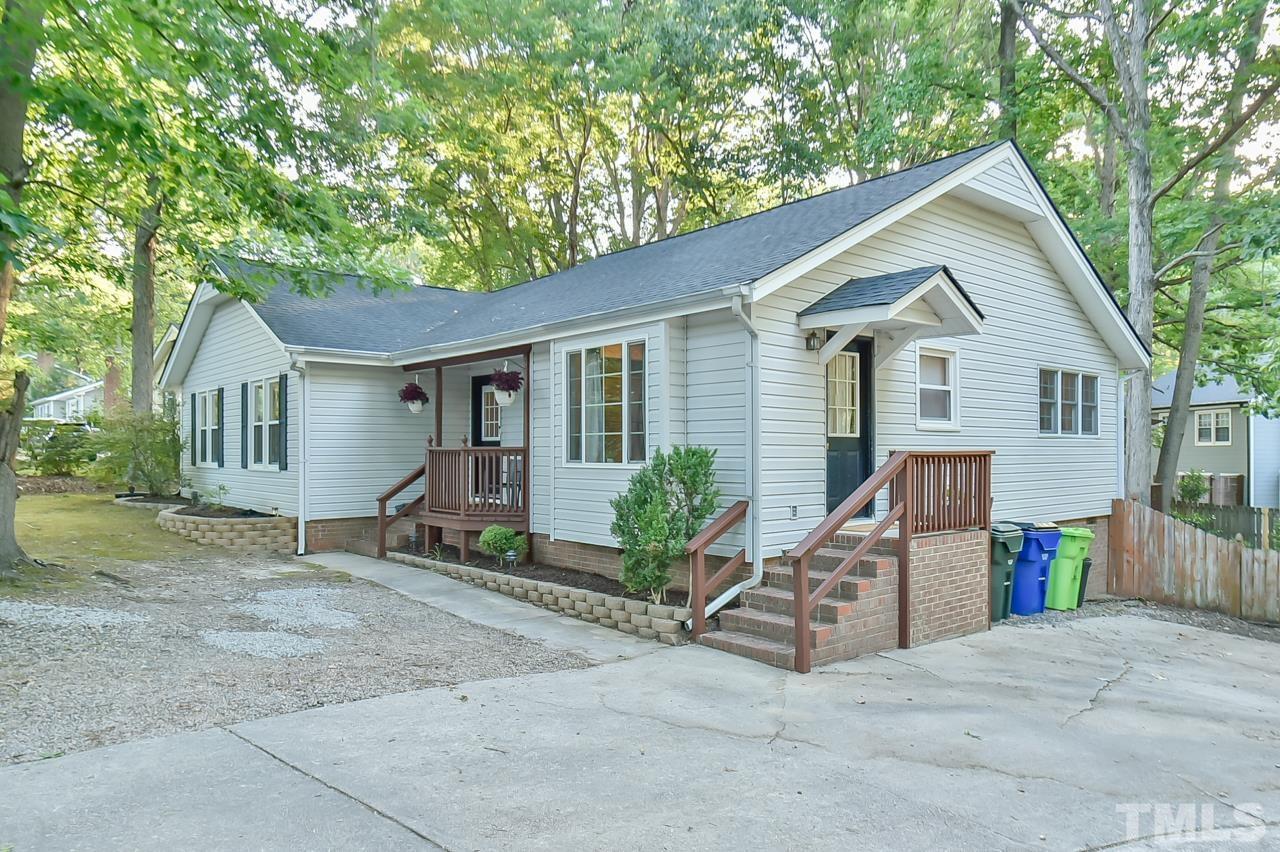 7204 Ray Road Raleigh, NC 27613 - Photo 2 of 40 a white house that has a tree in front of it