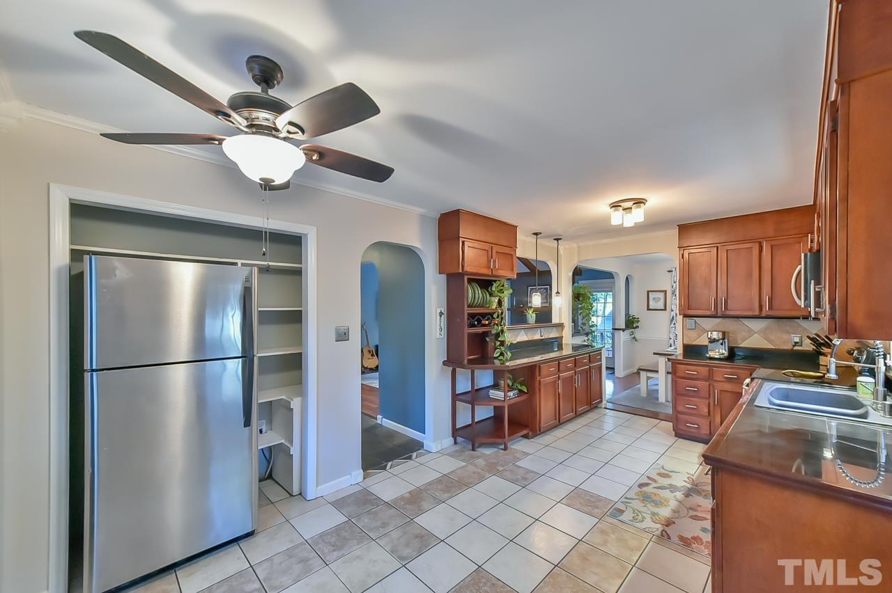 7204 Ray Road Raleigh, NC 27613 - Photo 26 of 40 a kitchen with stainless steel appliances granite countertop a refrigerator a stove a sink and a refrigerator