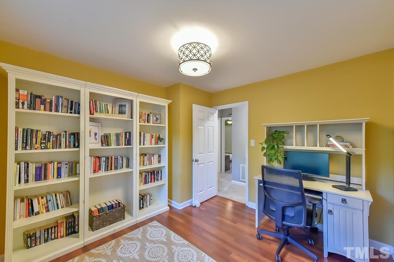 7204 Ray Road Raleigh, NC 27613 - Photo 30 of 40 a view of a workspace with furniture and a book shelf