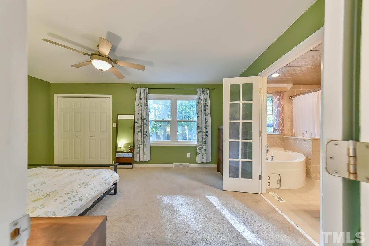 7204 Ray Road Raleigh, NC 27613 - Photo 35 of 40 a spacious bedroom with a bed and glass door