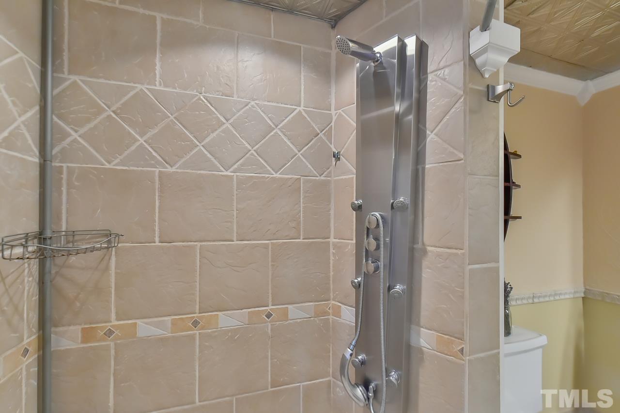 7204 Ray Road Raleigh, NC 27613 - Photo 38 of 40 a bathroom with a shower and a glass door shower