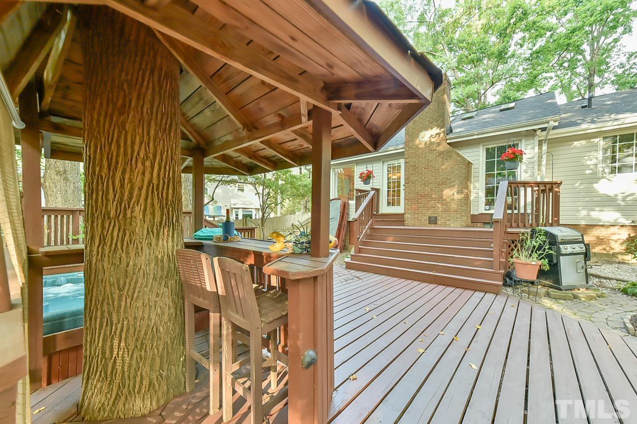 7204 Ray Road Raleigh, NC 27613 - Photo 7 of 40 a view of a patio with table and chairs and wooden floor