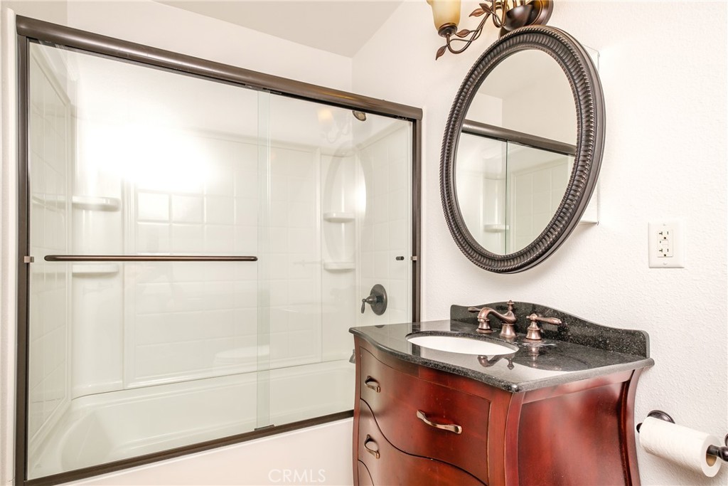 19670 Tonkawan Road Apple Valley, CA 92307 - Photo 18 of 29 a bathroom with a sink a mirror and a shower