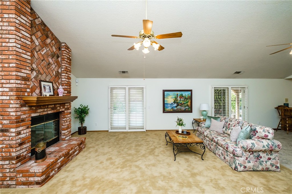 19670 Tonkawan Road Apple Valley, CA 92307 - Photo 2 of 29 a living room with furniture and a fireplace