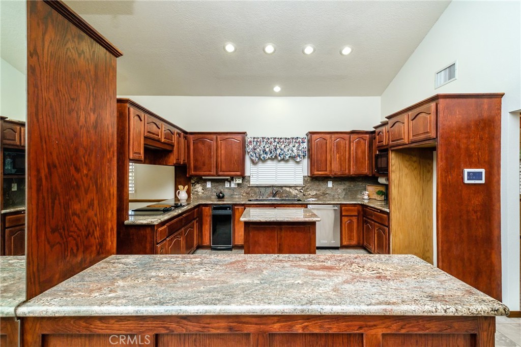 19670 Tonkawan Road Apple Valley, CA 92307 - Photo 8 of 29 a kitchen with stainless steel appliances granite countertop wooden cabinets and granite counter tops