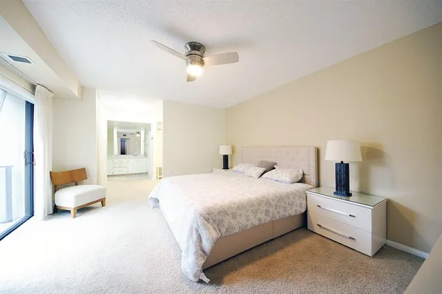 a bedroom with bed and white couch
