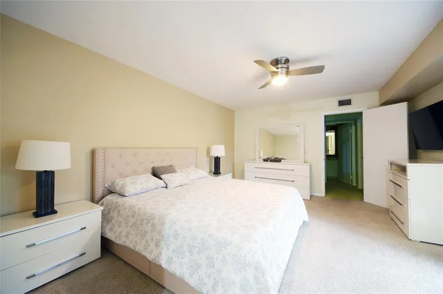 a bedroom with a large bed and a chandelier