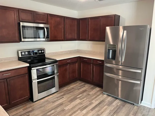 a kitchen with a refrigerator stove and microwave