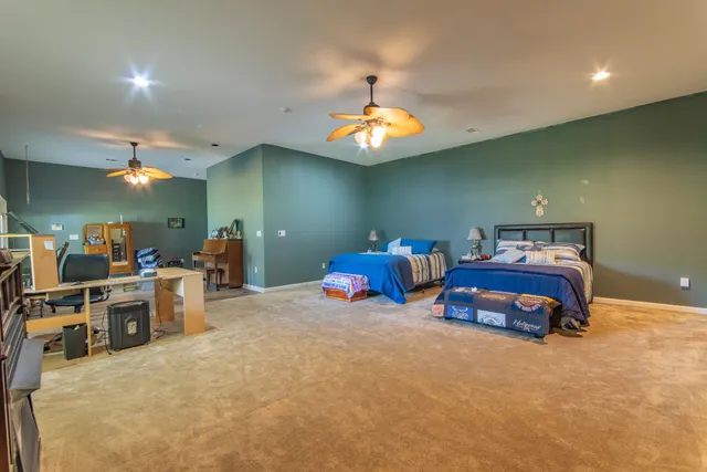 a view of a house with backyard and trees