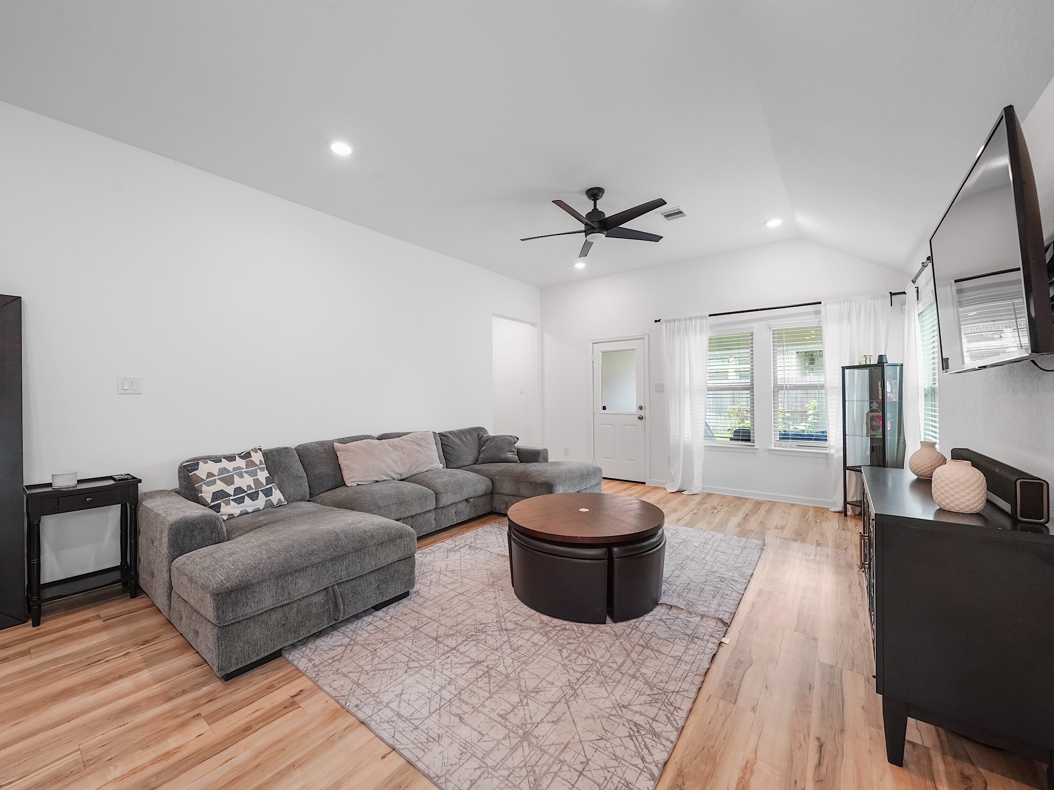 6210 Glenwick Park Road Katy, TX 77493 - Photo 11 of 25 Gather in this spacious family room featuring ample space for sectional seating, a large area rug, and modern finishes—perfect for hosting game nights or movie marathons.