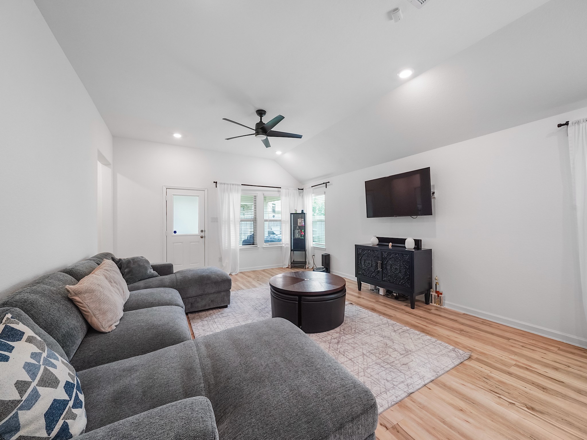6210 Glenwick Park Road Katy, TX 77493 - Photo 10 of 25 This light-filled living room offers plenty of space to relax, with a wall of windows overlooking the backyard and direct access to the covered patio—perfect for indoor-outdoor living.
