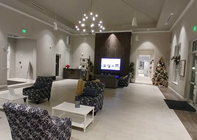 a living room with furniture and a chandelier