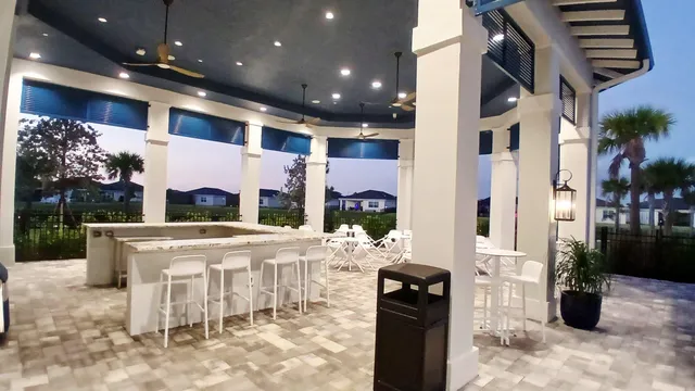 a view of a patio with dining table and chairs