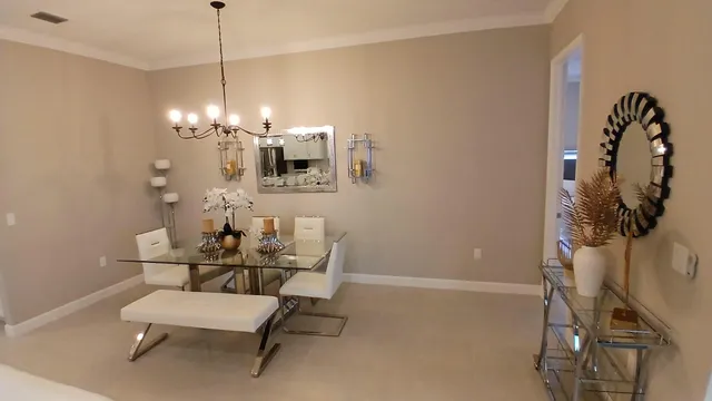 a view of a dining room with furniture and chandelier