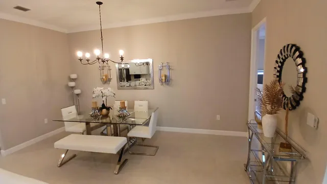 a view of a dining room with furniture and chandelier
