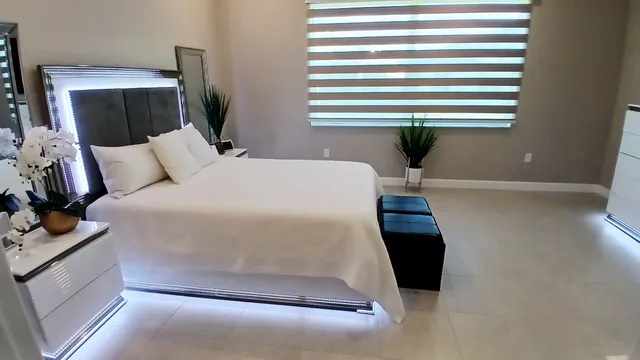 a bedroom with a bed and a mirror
