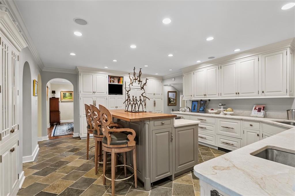 1909 Highgate Road Pittsburgh, PA 15241 - Photo 12 of 47 a kitchen with stainless steel appliances kitchen island granite countertop a table chairs sink and cabinets