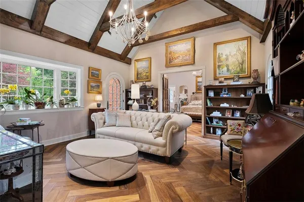 a living room with furniture a flat screen tv and a large window