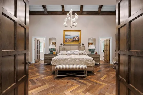 a bedroom with a bed and a chandelier