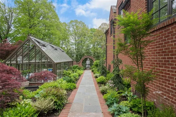 a view of a backyard with plants and a patio