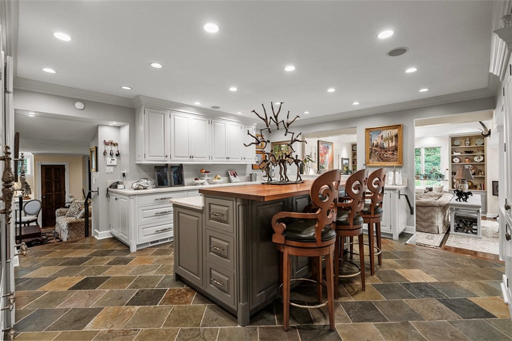 1909 Highgate Road Pittsburgh, PA 15241 - Photo 9 of 47 a kitchen with stainless steel appliances kitchen island granite countertop a table and chairs in it