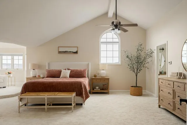 a bedroom with furniture and a chandelier