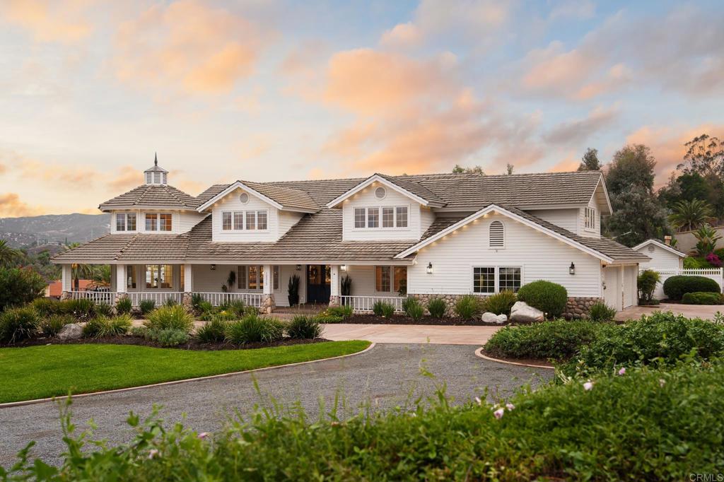 12212 Rockstream Road Lakeside, CA 92040 - Photo 3 of 36 a view of a white house next to a yard with big trees