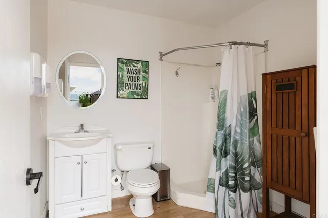a bathroom with a toilet sink and shower