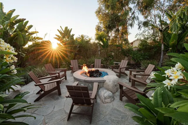 a view of a backyard with sitting area and furniture