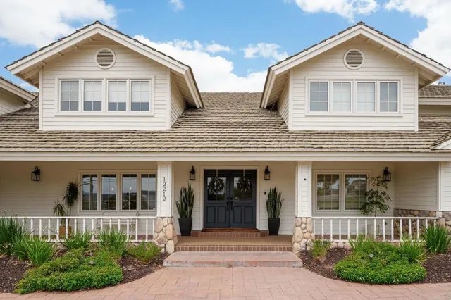 a front view of house with a garden