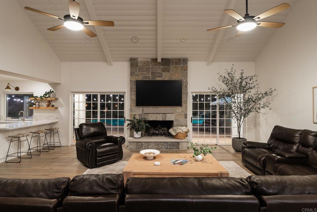 12212 Rockstream Road Lakeside, CA 92040 - Photo 6 of 36 a living room with furniture a fireplace and a flat screen tv
