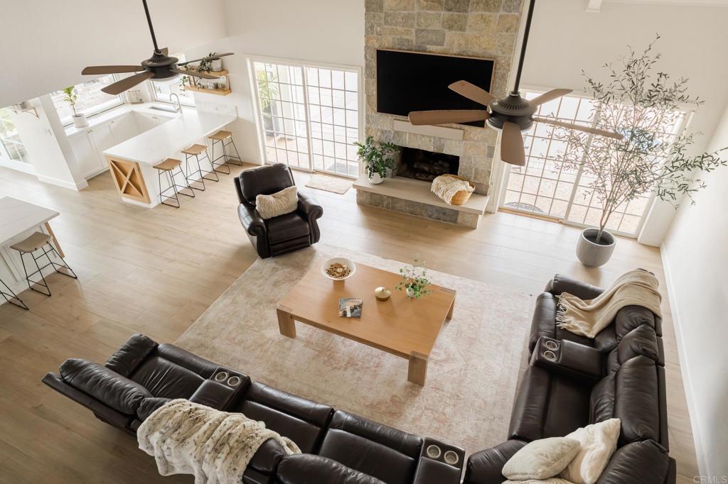 12212 Rockstream Road Lakeside, CA 92040 - Photo 8 of 36 a living room with furniture a fireplace and a flat screen tv