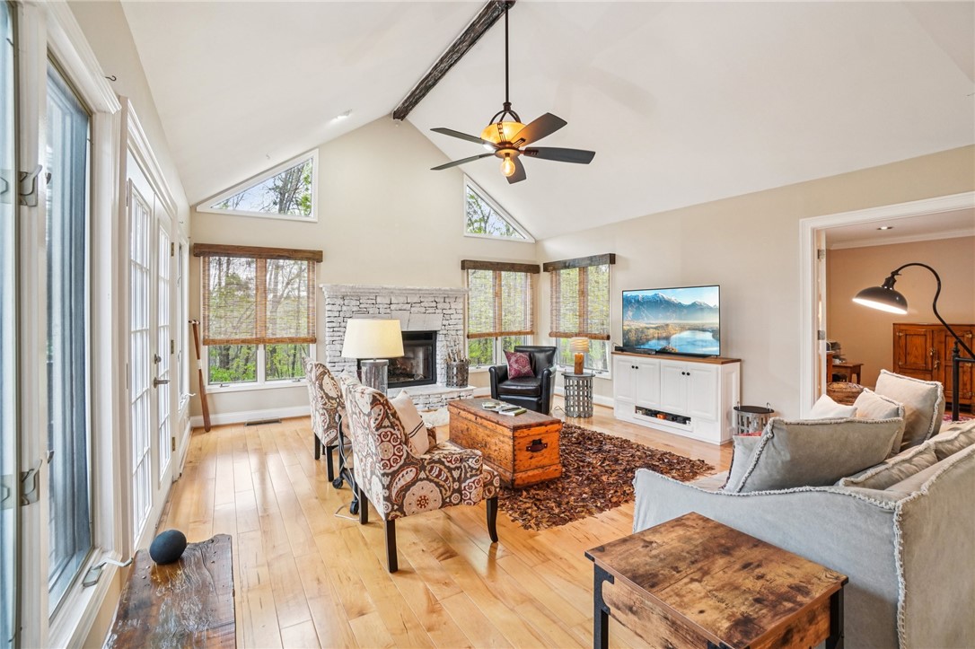 120 Beacon Ridge Circle Salem, SC 29676 - Photo 14 of 48 This bright living space features tall ceilings and a cozy fireplace, creating an inviting atmosphere.