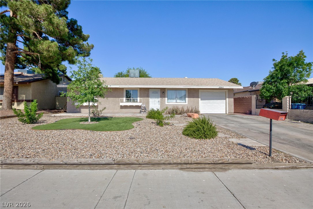 3640 North Walnut Road Las Vegas, NV 89115 - Photo 3 of 38 A well-maintained facade with an attached garage and desert landscaping welcomes you home.