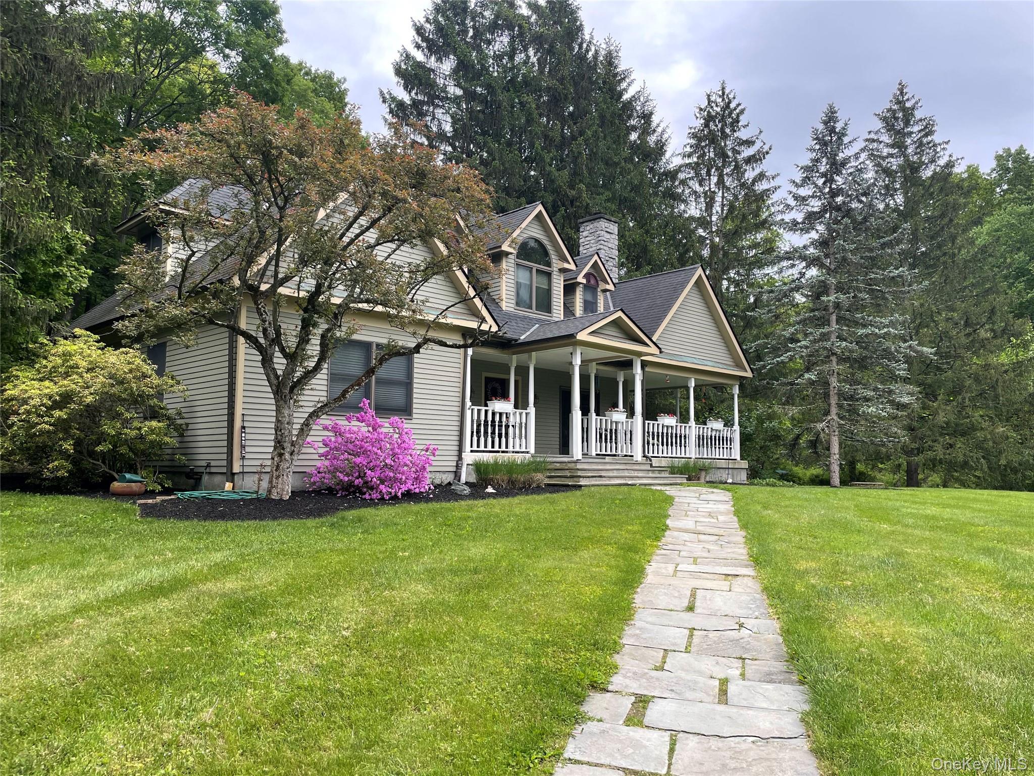 a front view of a house with a garden