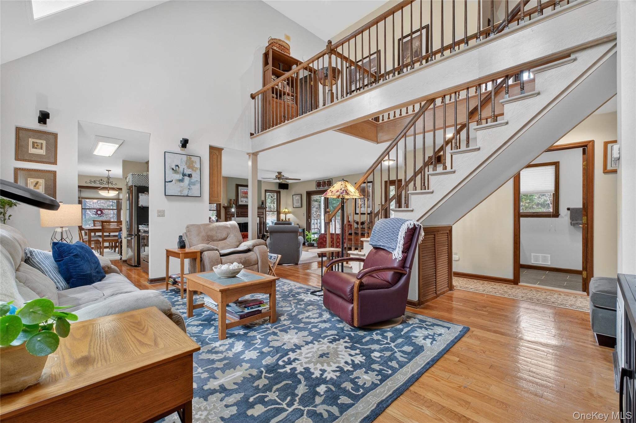 256 Overlook Road Poughkeepsie, NY 12603 - Photo 12 of 47 a living room with furniture stairs and a rug