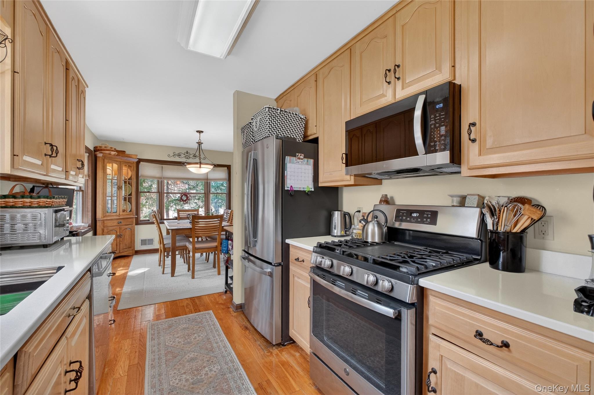256 Overlook Road Poughkeepsie, NY 12603 - Photo 14 of 47 a kitchen with stainless steel appliances granite countertop a stove a sink and a microwave