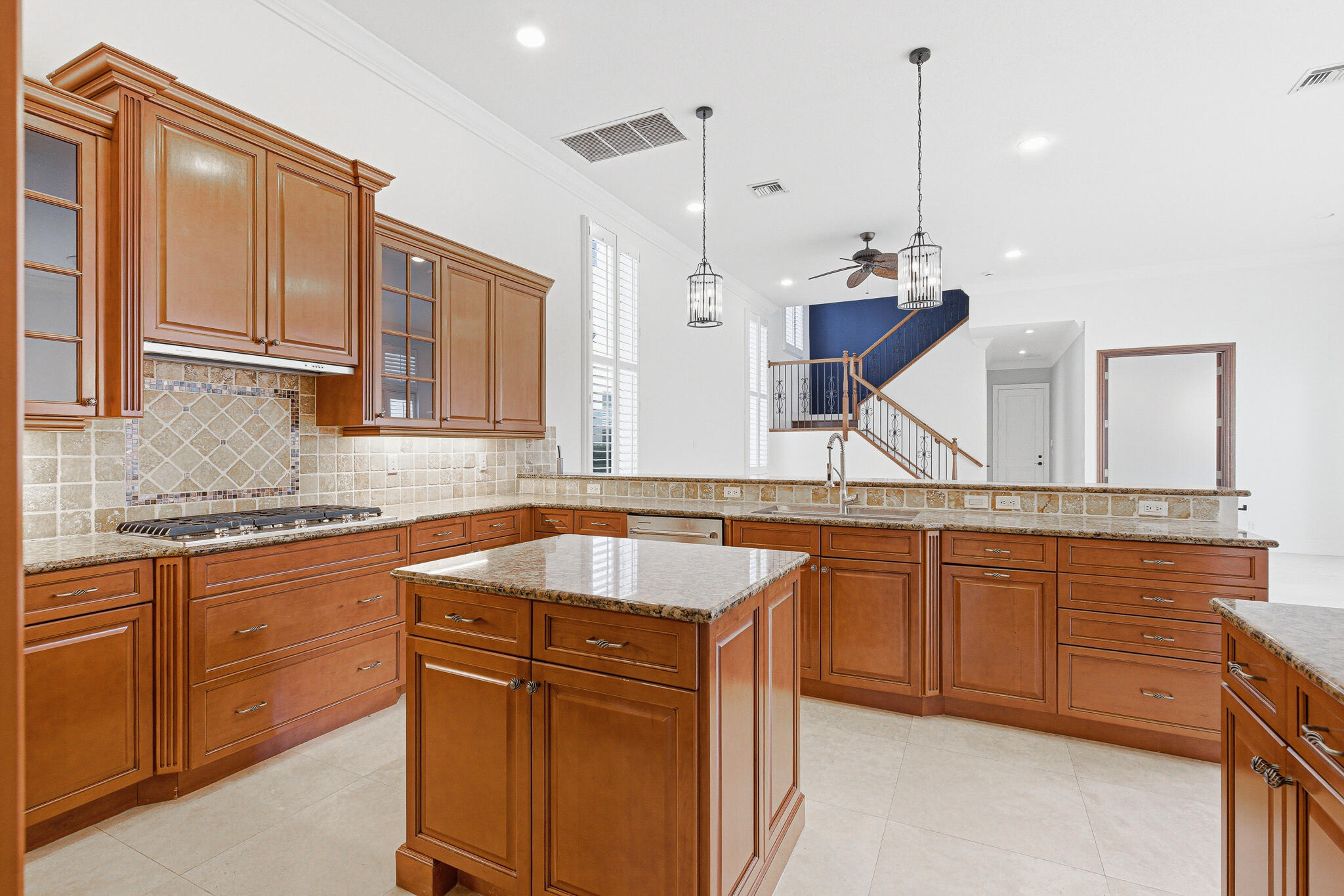 17550 Circle Pond Court Boca Raton, FL 33496 - Photo 21 of 99 a kitchen with stainless steel appliances granite countertop a sink a stove and a wooden cabinets