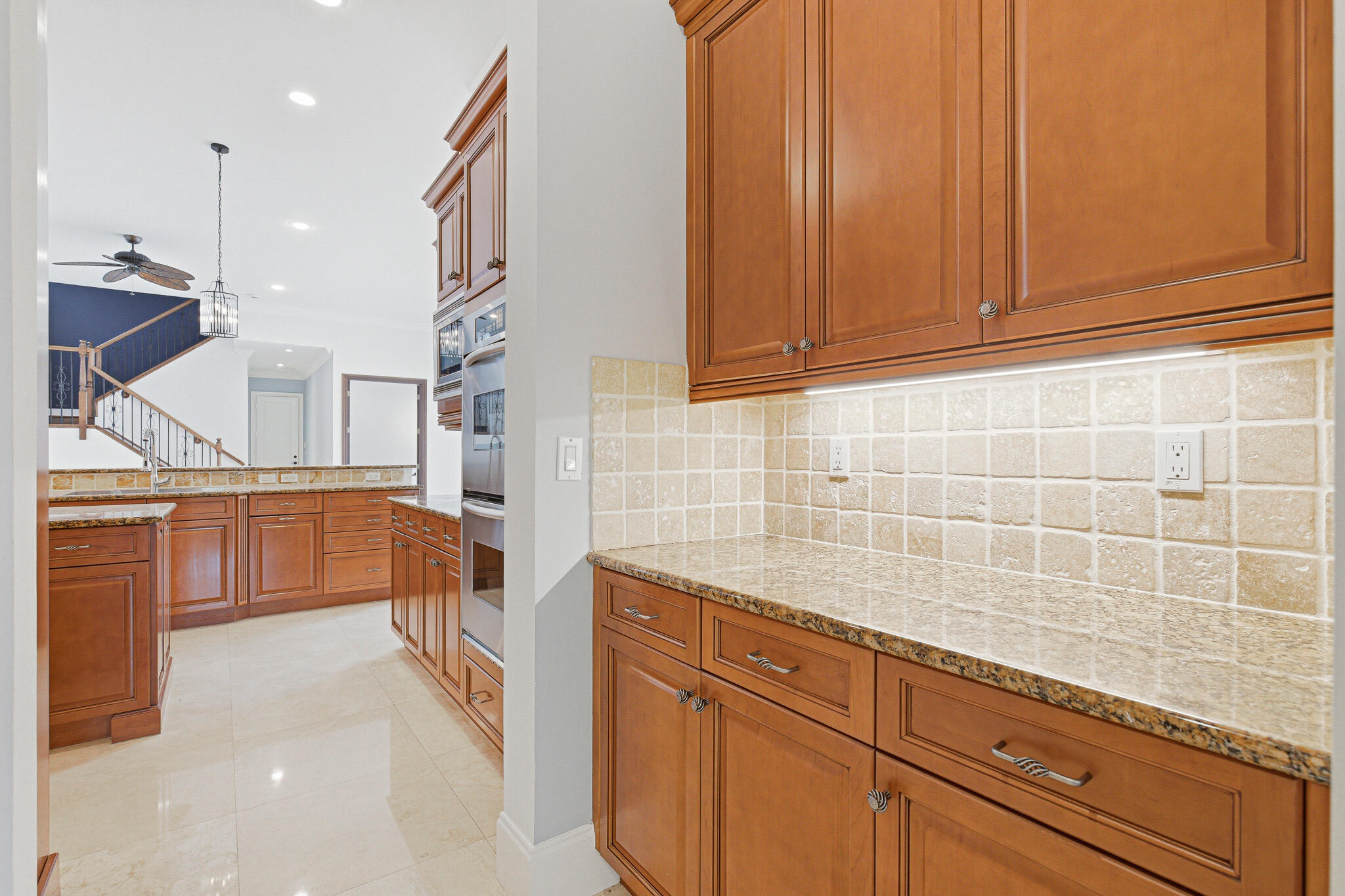 17550 Circle Pond Court Boca Raton, FL 33496 - Photo 22 of 99 a kitchen with stainless steel appliances granite countertop a sink and cabinets