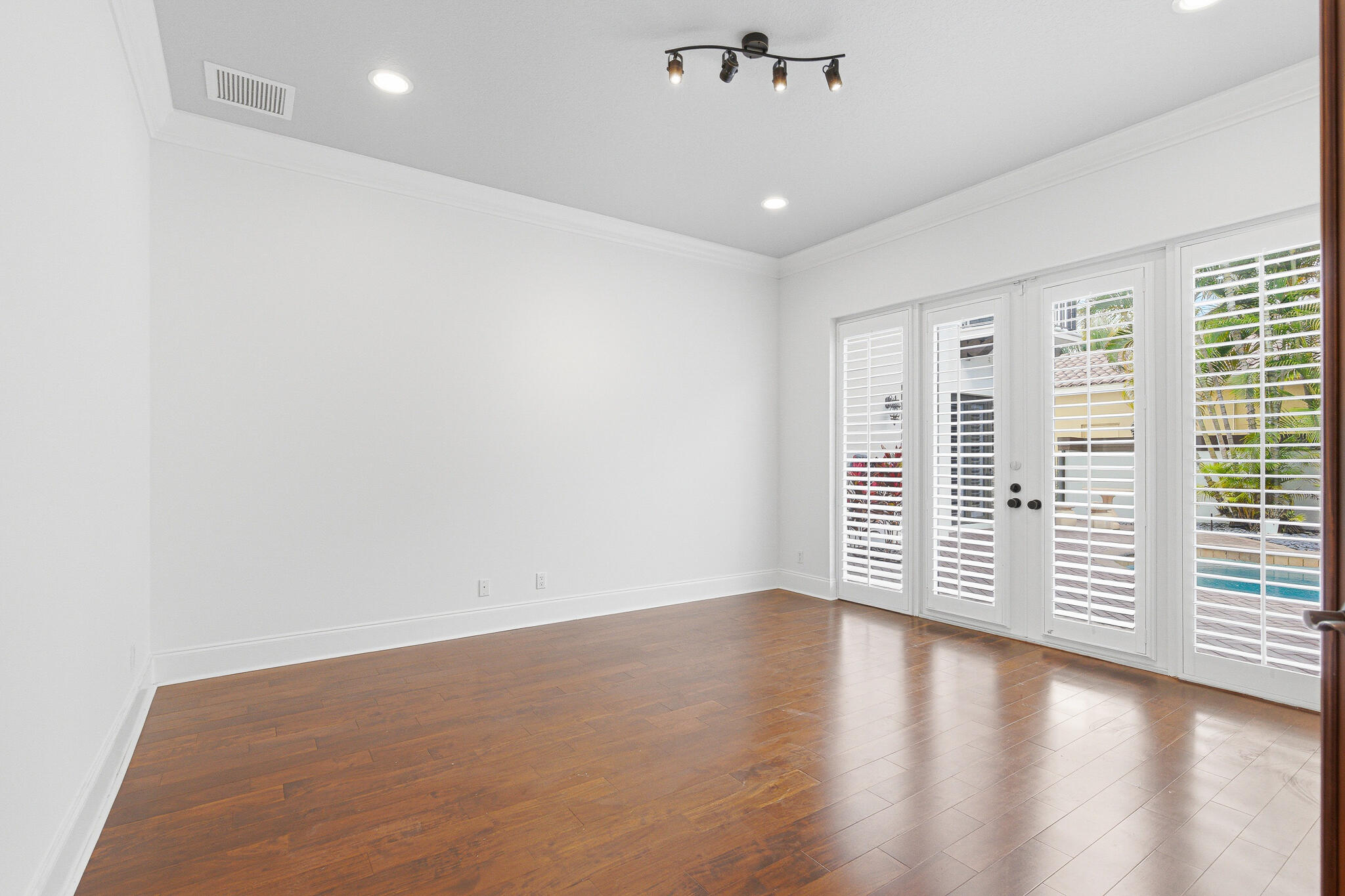 17550 Circle Pond Court Boca Raton, FL 33496 - Photo 43 of 99 an empty room with wooden floor and windows