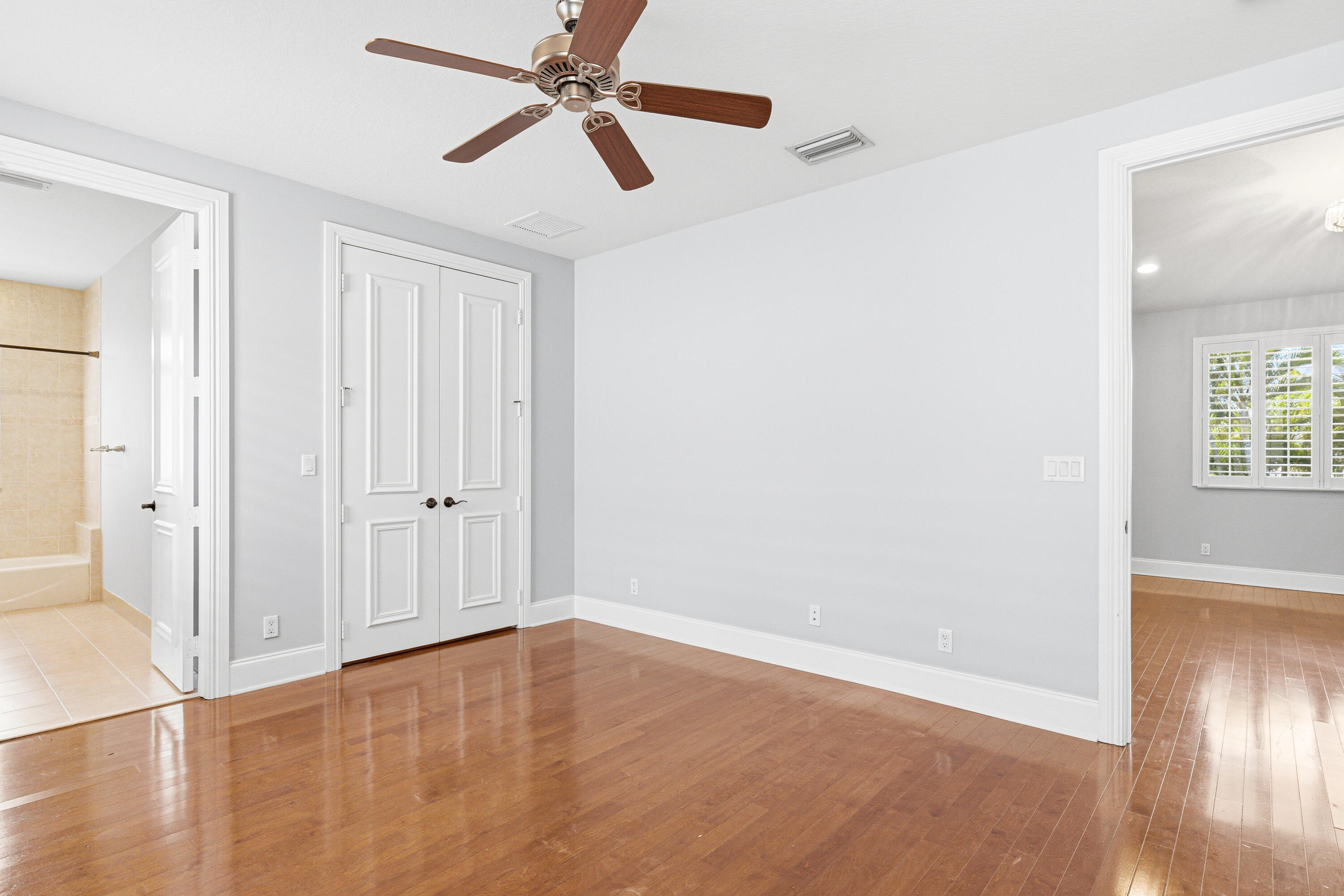 17550 Circle Pond Court Boca Raton, FL 33496 - Photo 58 of 99 an empty room with wooden floor closet and windows