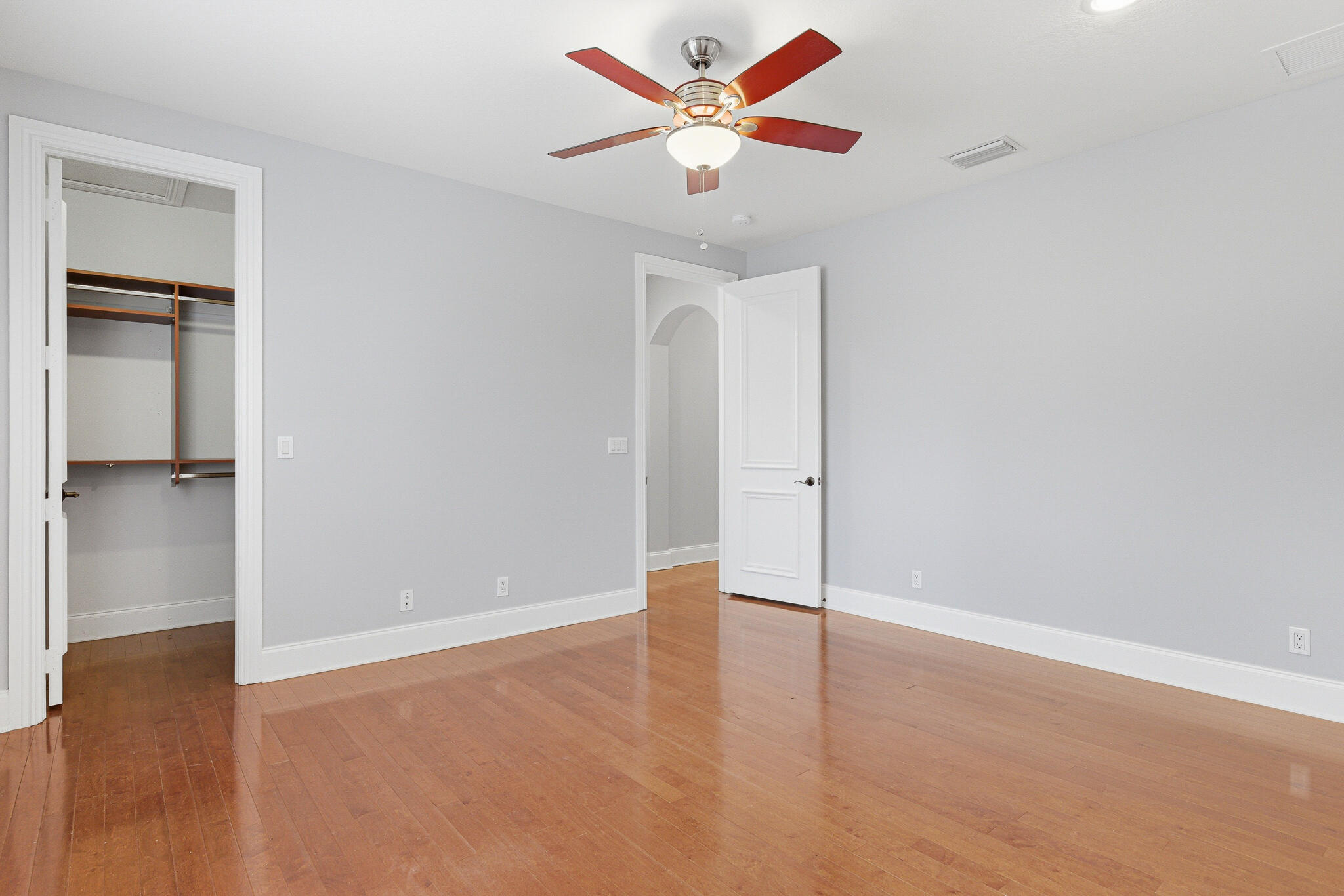 17550 Circle Pond Court Boca Raton, FL 33496 - Photo 61 of 99 an empty room with a ceiling fan and wooden floor