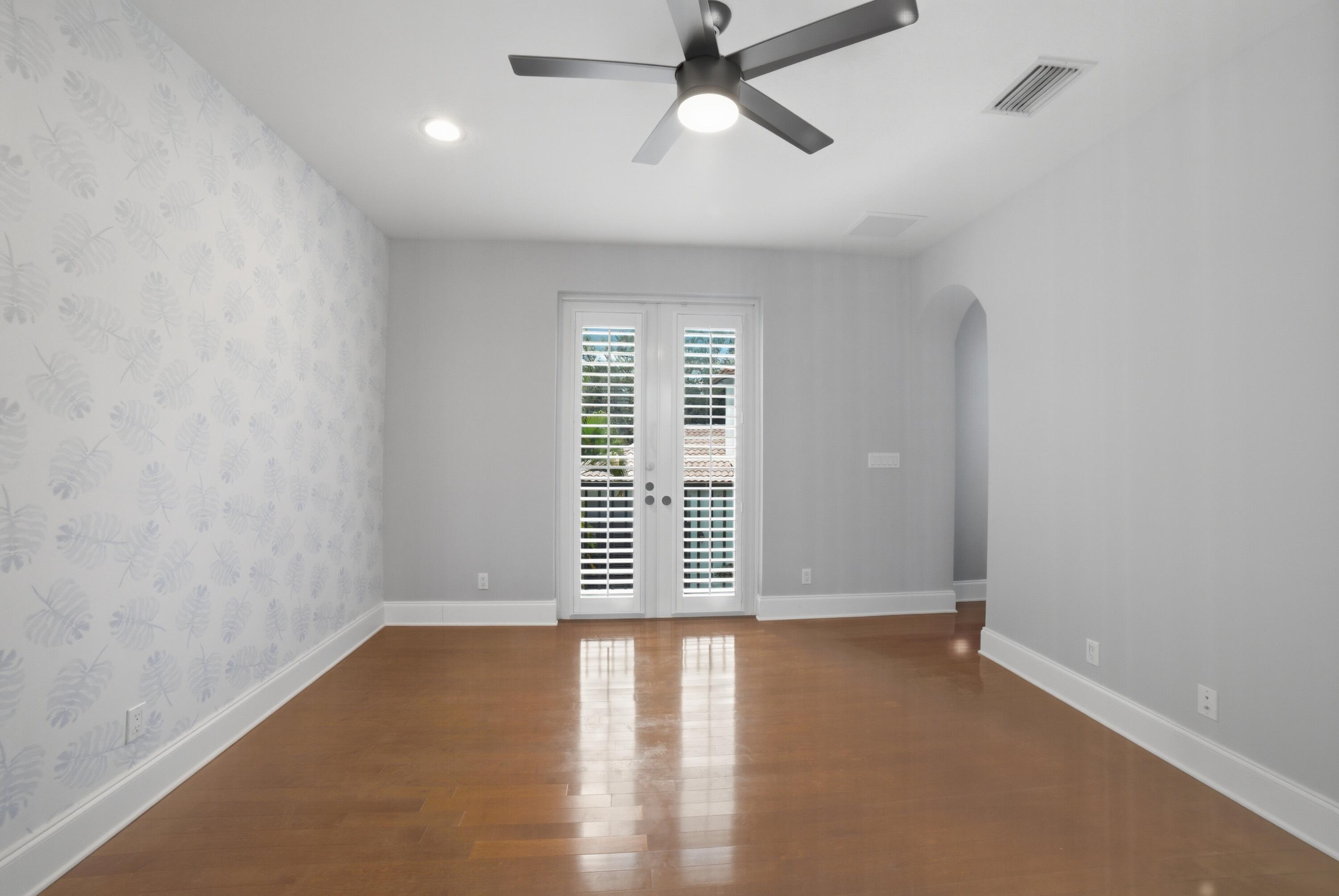 17550 Circle Pond Court Boca Raton, FL 33496 - Photo 68 of 99 an empty room with wooden floor windows and ceiling fan