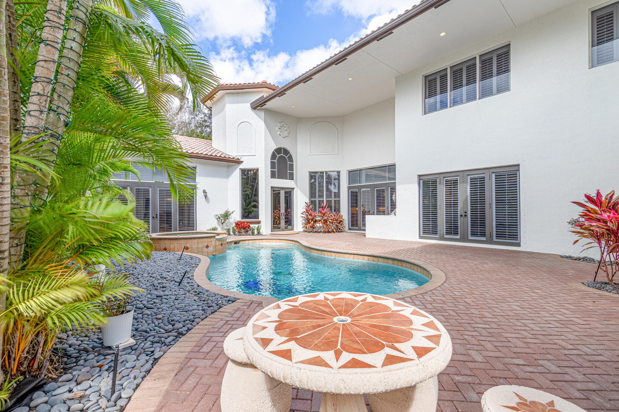 17550 Circle Pond Court Boca Raton, FL 33496 - Photo 10 of 99 a view of a swimming pool with a patio