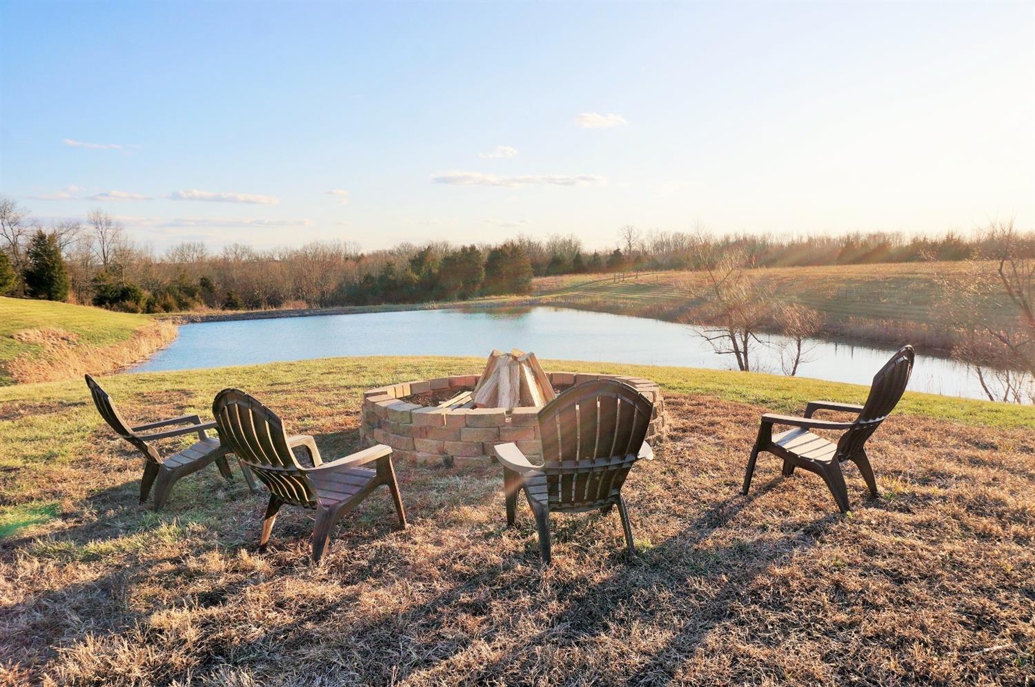 8305 Bocock Road Dillsboro, IN 47018 - Photo 2 of 80 Enjoy this pond side firepit area, and the sunsets!